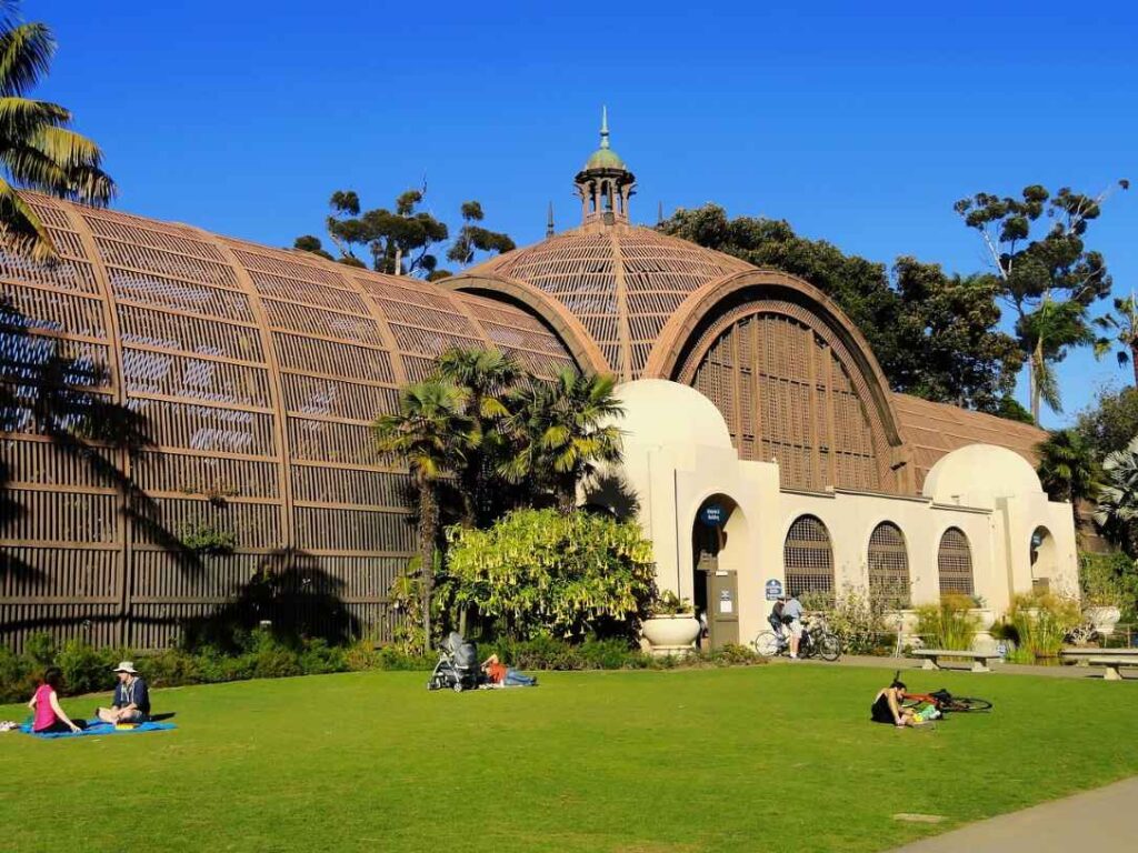 Botanical Building with people relaxing on the lawn at Balboa Park in San Diego
