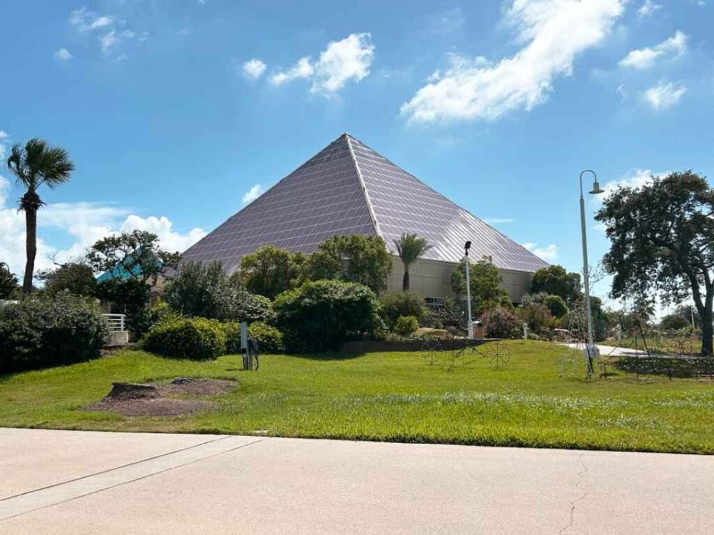 Glass pyramid at Moody Gardens surrounded by palms in Galveston, Texas
